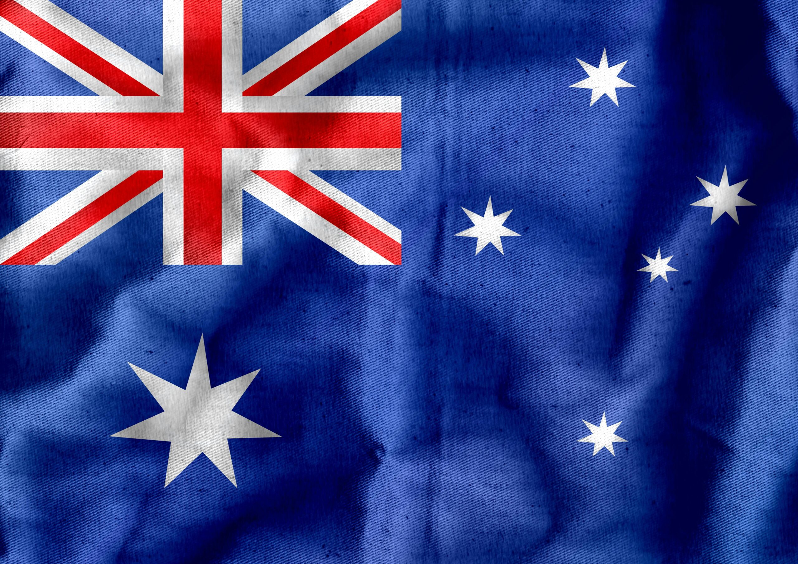Żywa, szczegółowa tekstura australijskiej flagi z gwiazdami i Union Jack.