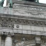 Zbliżenie na skomplikowane rzeźby i łuki łuku Cinquantenaire w Brukseli, Belgia.