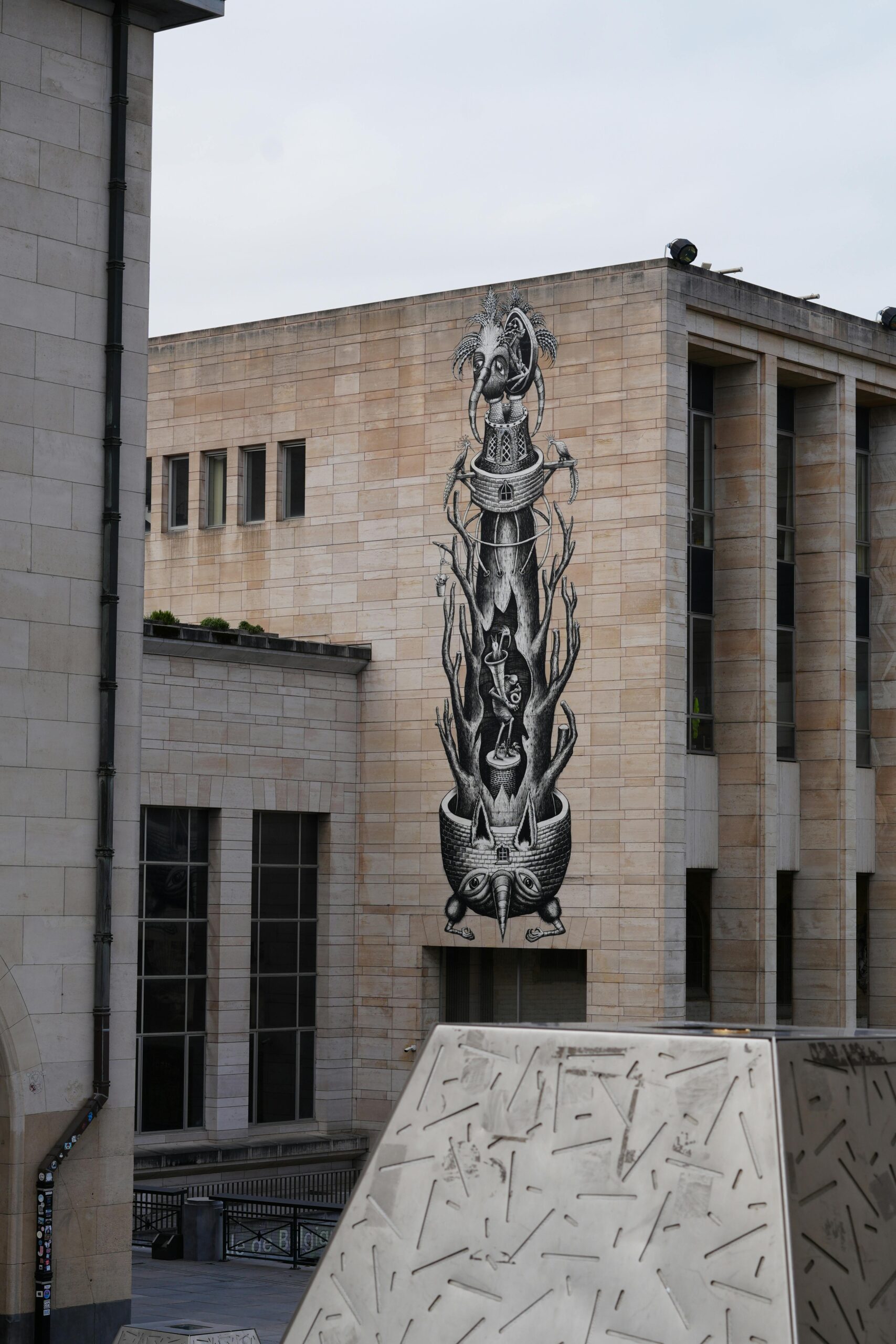 Uderzający czarno-biały mural zdobi nowoczesny budynek w Brukseli w Belgii.