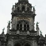 Zbliżenie ozdobnej gotyckiej wieży na Grand Place, wpisanej na Listę Światowego Dziedzictwa UNESCO w Brukseli.