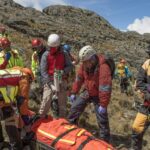 Zespół ratunkowy pomaga rannemu wspinaczowi w nierównych górach La Paz w Boliwii. 