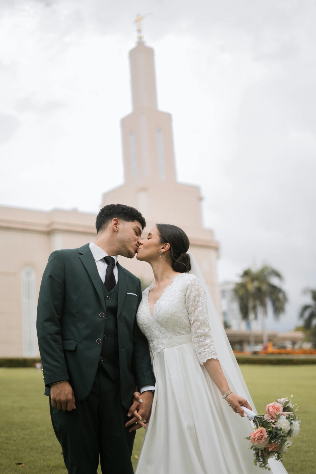 dominikana Narzeczeni całują się w świątyni Santo Domingo LDS w bujnej zieleni.