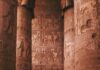 Turysta zwiedzający misternie rzeźbione kolumny świątyni Dendera w Egipcie.