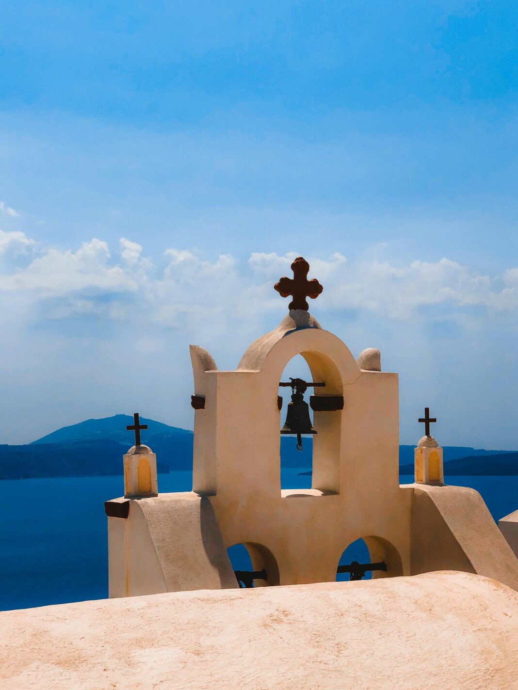 grecja Kultowa dzwonnica na Santorini w Grecji, z widokiem na morze i czystym, błękitnym niebem.