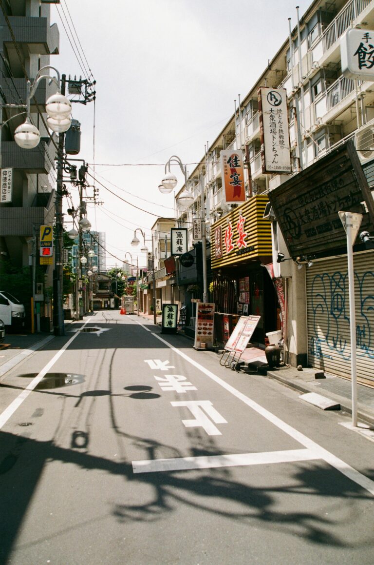 Pusta scena uliczna w Tokio, Japonia, przedstawiająca tradycyjne japońskie witryny sklepowe i architekturę miejską.