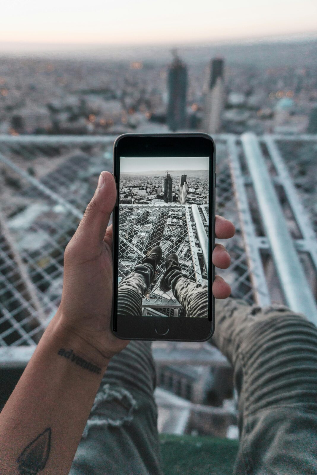 jordania Ręka trzymająca smartfon rejestrujący pejzaż Ammanu w Jordanii z perspektywy dachu.