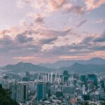 Odkryj czarujący pejzaż miejski Seulu na tle pagórkowatych gór o zmierzchu.