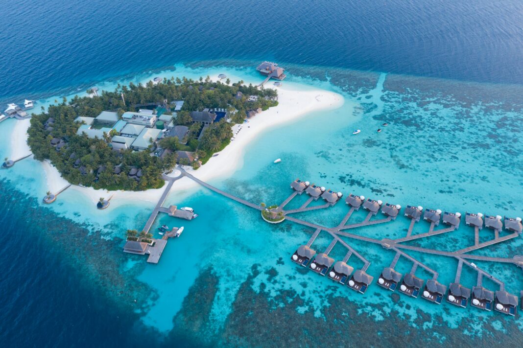 mauritius Oszałamiający widok z lotu ptaka na luksusowy kurort na tropikalnej wyspie na Malediwach, z turkusowymi wodami i bungalowami nad wodą.
