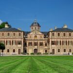Historyczny zamek Schloss Favourite w Rastatt w Niemczech, prezentujący architekturę barokową i bujne trawniki.