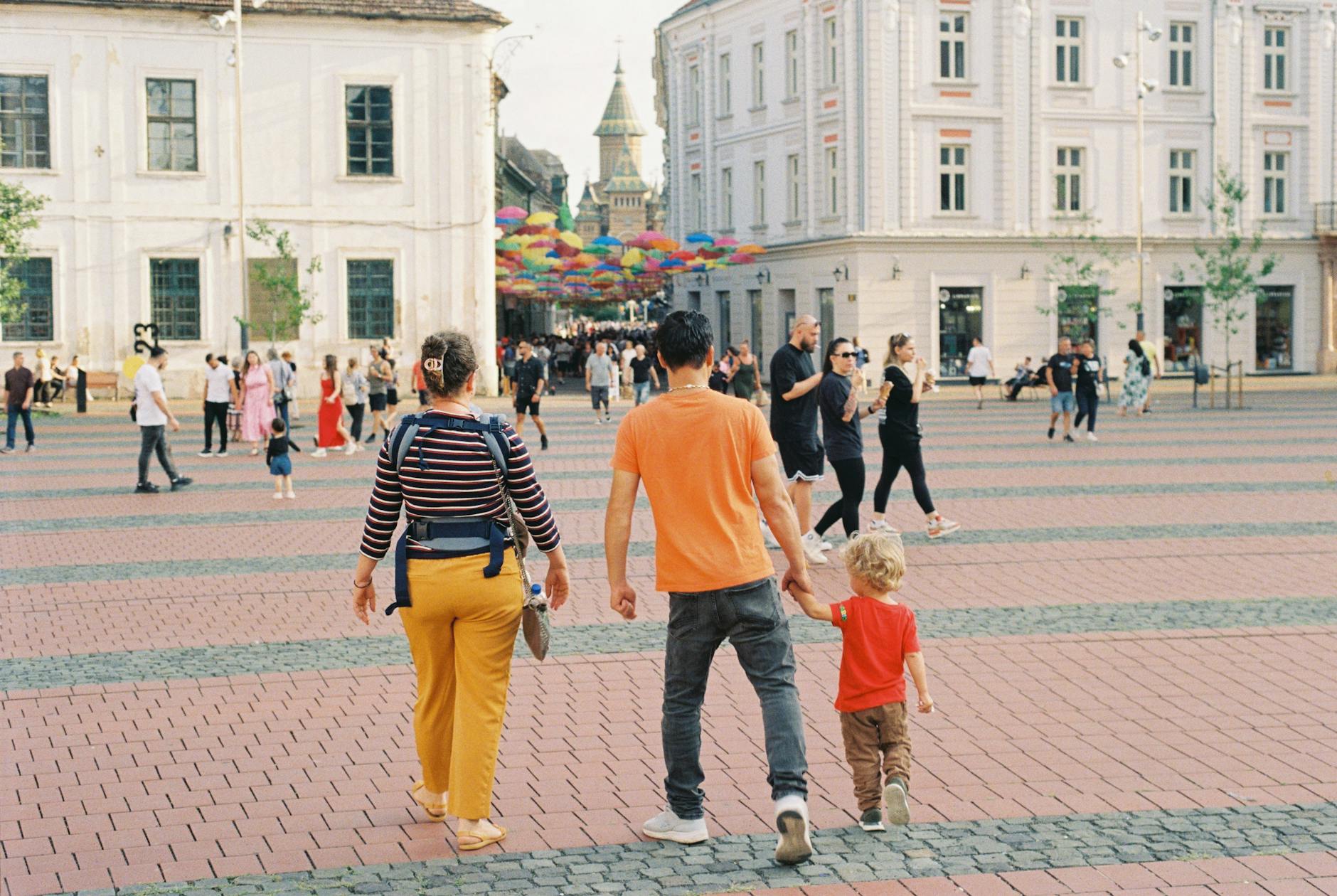 Rodzina spaceruje po kolorowym placu w centrum Warszawy